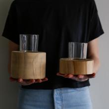 person holding two candle holders